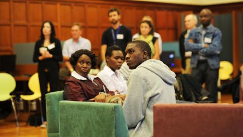 Group of postdoc students listen to speaker (not pictured).